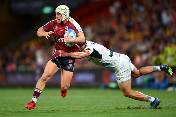 Mac Grealy of the Reds is tackled during the round three Super Rugby Pacific match between Queensland Reds and Chiefs.