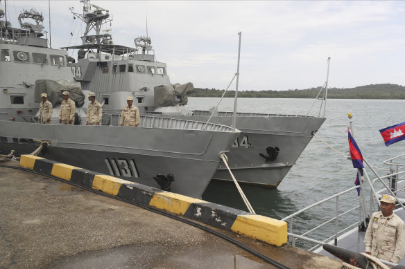 Cambodian navy crew members stand on a navy patrol boat at the Ream Naval Base in Sihanoukville, southwest of Phnom Penh, Cambodia. 