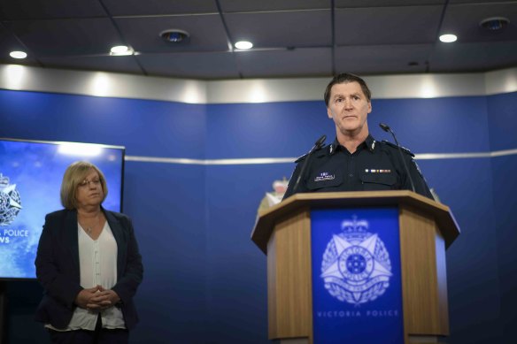 Police Minister Lisa Neville watches as Deputy Commissioner Shane Patton addresses the media on Tuesday.