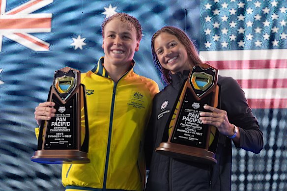 Swimmers of the meet winners Samuel Short, of Australia, left, and Kate Douglass, of the United States, hold their trophies at the Pan Pacific Championships in Irvine. 