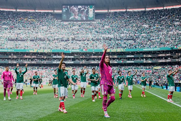 Mexico players salute the crowd after their 2-0 defeat of South Africa.