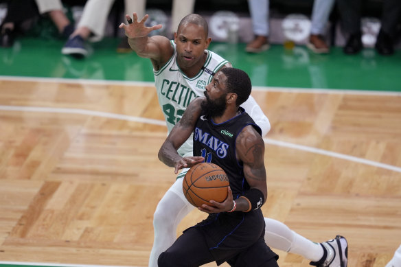 Dallas Mavericks guard Kyrie Irving drives toward the basket.