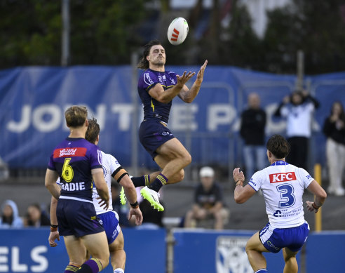 Ryan Papenhuyzen leaps high for the ball.