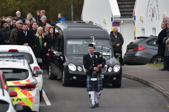 Mourners watch the arrival of the coffin as they attend the funeral of Martin McGill at St Michael’s church in Donegal, Ireland on Tuesday. 
James O’Flaherty was buried on Wednesday.