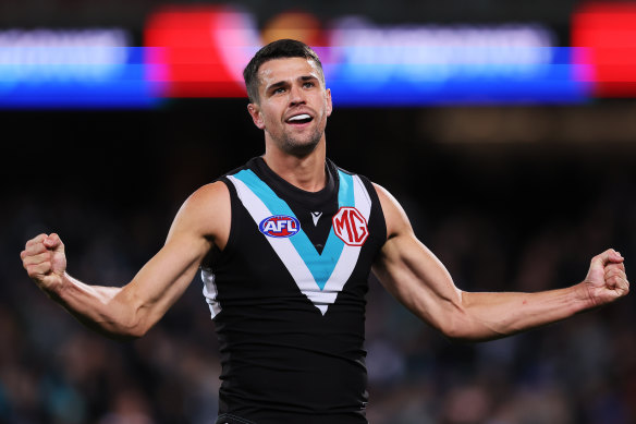 Ryan Burton celebrates his booming goal in Port’s win over Geelong. 