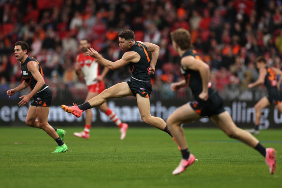 Toby Greene of the Giants kicks the ball.