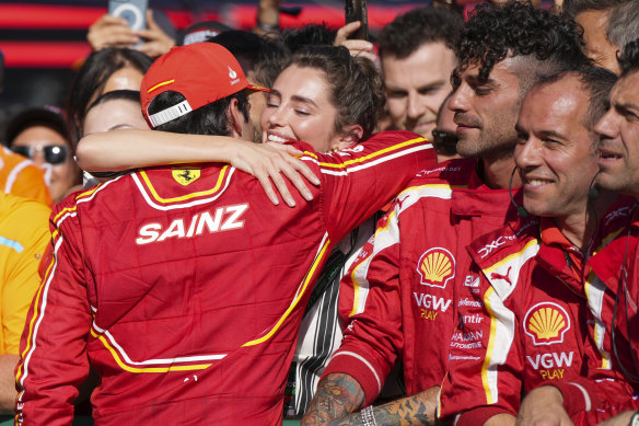 Carlos Sainz is embraced after his victory.