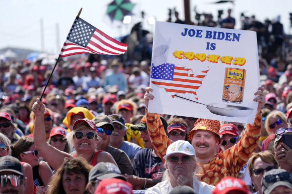 Supporters wait for Donald Trump to take the stage ahead of the chaos.