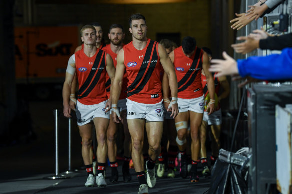 Zach Merrett leads the Bombers out.