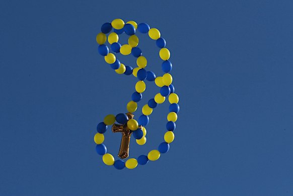 Balloons are released during the funeral of John Versace on Friday.