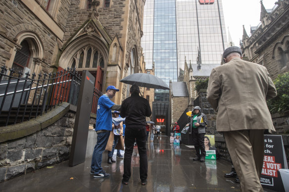 People braving the weather to vote early in the city on Monday.