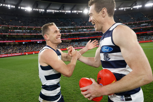 Joel Selwood (left) and Jeremy Cameron of the Cats celebrate after winning the preliminary final against Brisbane Lions on September 16.