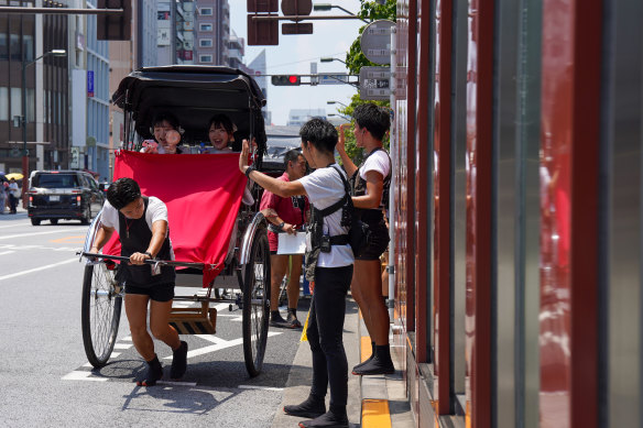 Rickshaw driver Sora Suzuki, 24, sets on in a sprint around the streets of Tokyo’s Asakusa district. Business is “super busy”, he says. 