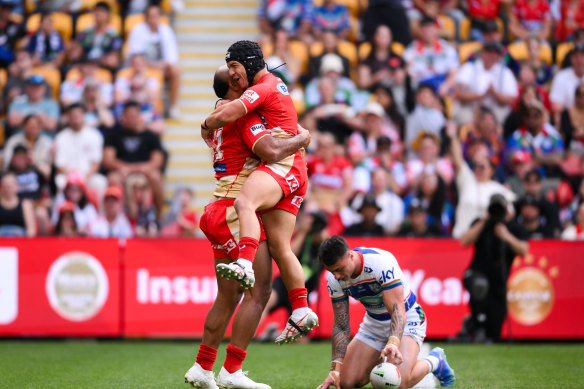 Kodi Nikorima and Felise Kaufusi celebrate for the Dolphins.