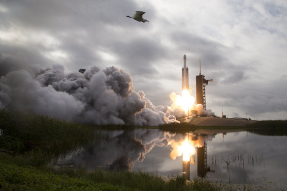 Private companies – like SpaceX, whose Falcon Heavy rocket is pictured carrying a satellite – have entered the space race.