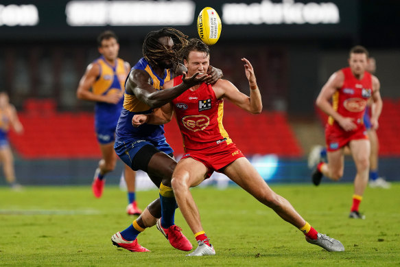 Jack Lukosius of the Suns competing with the Eagles' Nic Naitanui at Metricon Stadium on the Gold Coast on Saturday.