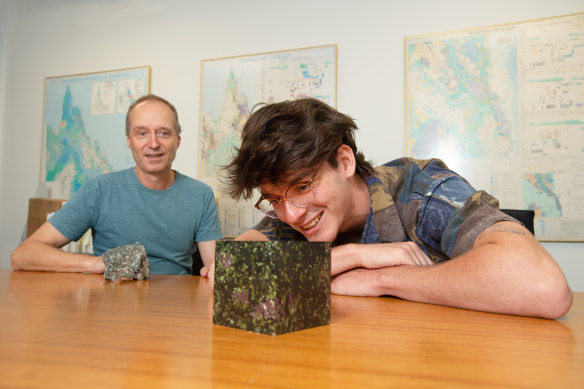 Researcher Carl Walsh (right) with Professor Balz Kamber and a sample of the type of rock used in their modelling.