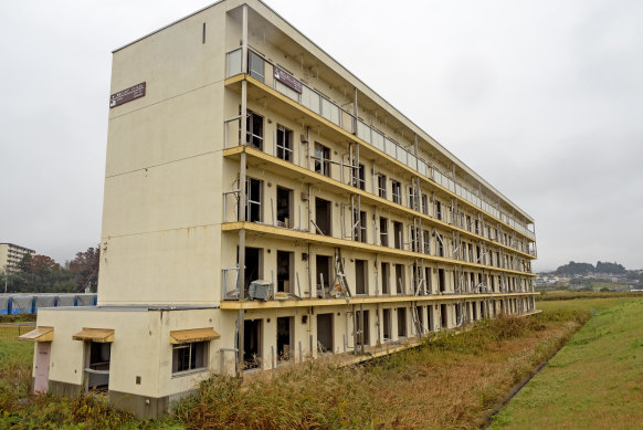 Apartment block in Rikuzentakata destroyed in the 2011 tsunami. A marker on the top floor notes the height of the wave.