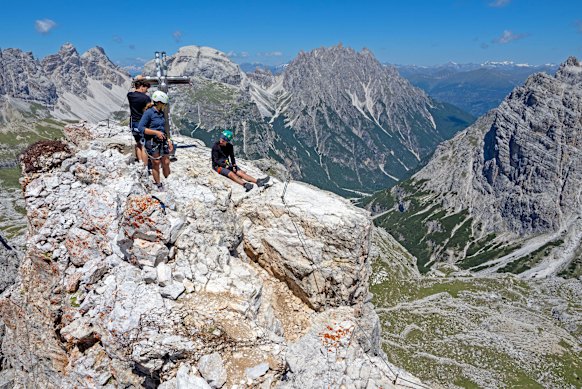 Climbers rest atop the Dolomites’ Torre di Toblin via ferrata.