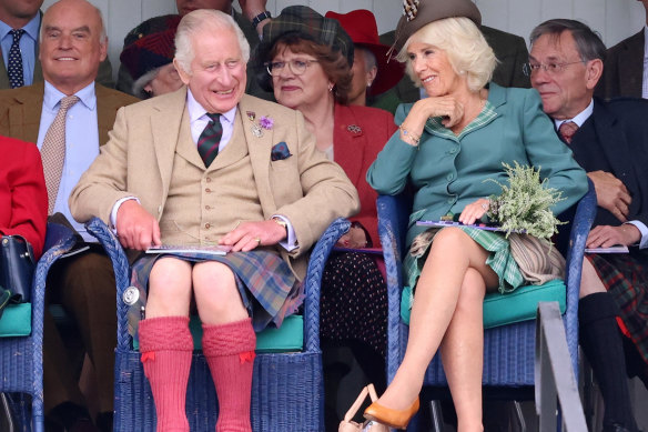 King Charles III and Queen Camilla laughing in Braemar, Scotland, on the weekend.