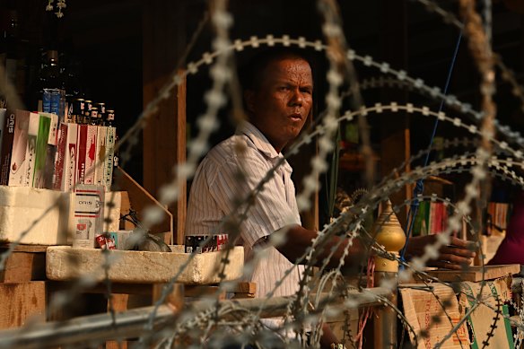 A man tends his market stall on a sandbar in the middle of the Moei River on the Thai- Myanmar border between Mae Sot and Myawaddy, Myanmar.