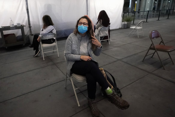 Angela Margos, a tourist on her way to visit Maui, Hawaii, sits in a waiting area of San Francisco airport for her test results before her flight.