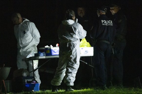 Forensics technicians at the Benaroon Drive home in Kendall.