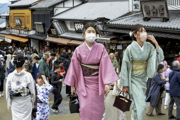 Don’t bother the Geishas. Visitors walk along a sightseeing destination in Kyoto, Japan.