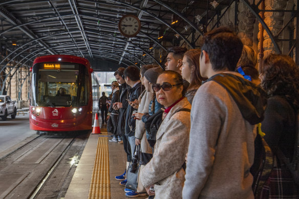 Passengers wait for the Inner West light rail at Central Station pre-COVID.