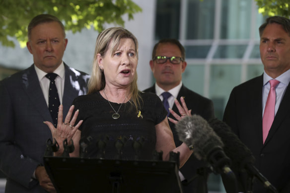 Veteran suicide campaigner Julie-Ann Finney, flanked by Opposition leader Anthony Albanese (left) and Labor MPs, says families won't be placated by the government's alternative to a royal commission.