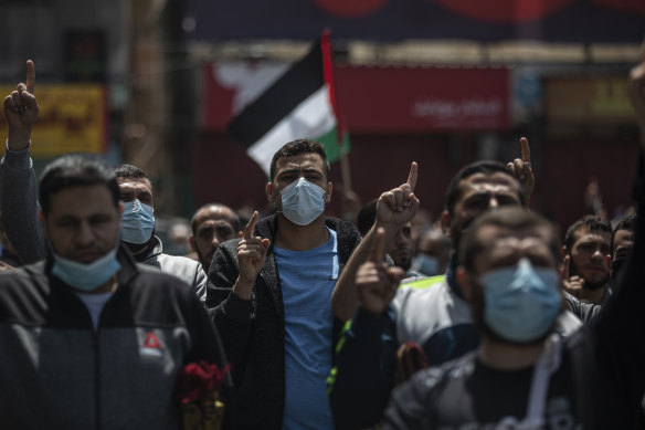 Palestinian Hamas supporters chant anti Israel slogans during a protest in solidarity with Muslim worshippers in Jerusalem.