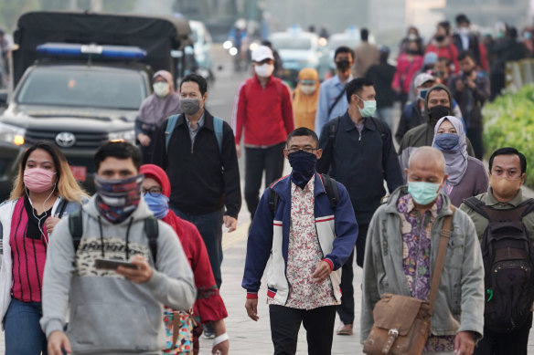 Commuters wear masks in Jakarta, Indonesia, on Friday. The country has the worst coronavirus outbreak in south-east Asia.