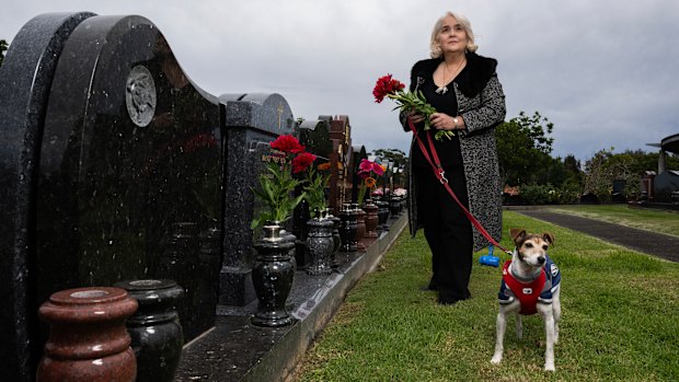 Carmen Terceiro visiting her father’s grave with  her 8-year-old Jack Russell, Milo. 