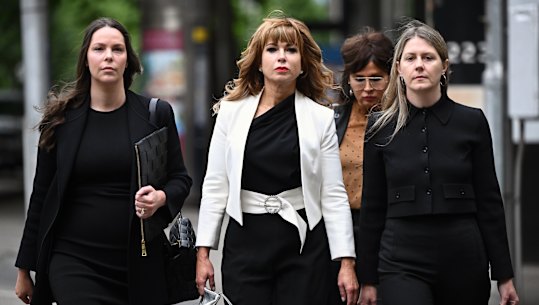 Emma Walters (2nd left) arrives at the Melbourne Magistrates Court in Melbourne, Friday, December 8, 2023. Emma Walters is the estranged wife of union boss John Setka, who has been accused of making threats to kill him.