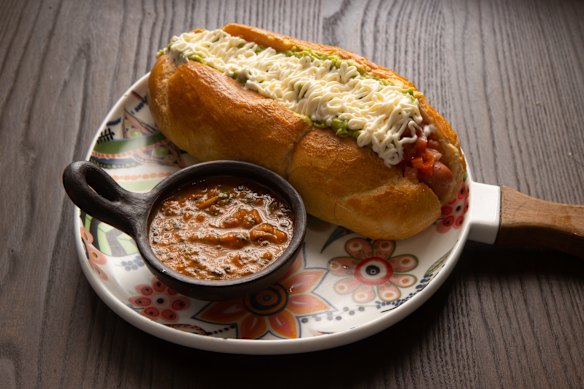 Completos (Chilean hot dogs) are tiger rolls cradling a simple frankfurt, diced tomato, avocado mash and mayonnaise.