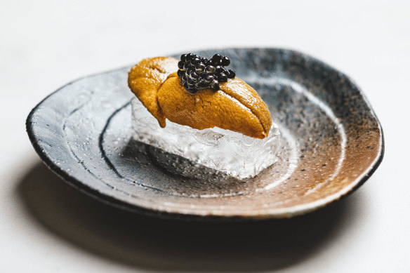 Sea urchin and caviar on transparent crystal bread.