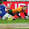 Australia’s Max Jorgensen, right, pounces on the ball to score a try during the rugby union Nations Series match between France and Australia in Saint-Denis, outside Paris, Saturday, Nov. 22, 2025. (AP Photo/Christophe Ena)