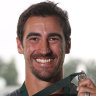Mitchell Starc with his new Allan Border Medal at Manuka Oval on Saturday. 
