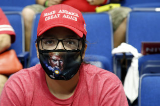 A Trump supporter wearing a face mask as they waited for his Tulsa rally to begin last month.