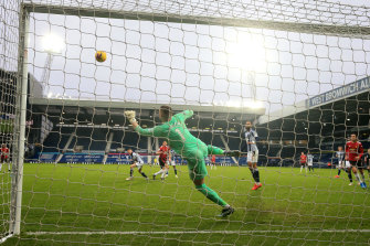 West Brom keeper Sam Johnstone saves a late Harry Maguire shot on goal for United.