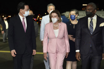 Nancy Pelosi, centre, arrives in Taipei.