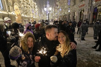 People celebrate the New Year in Nikolskaya street near an empty Red Square due to pandemic restrictions during New Year celebrations in Moscow. 
