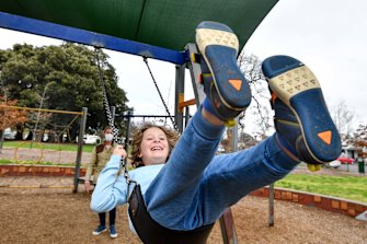 Toby Cummings’ son Louis. 8, enjoys his last swing at a public playground for at least two weeks.