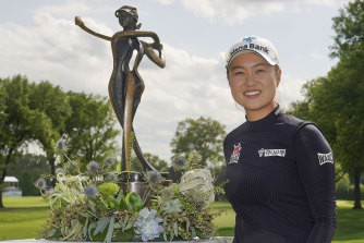 Minjee Lee, of Australia, poses with the trophy after winning the LPGA Cognizant Founders Cup golf tournament.