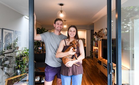 Mitch and Caitlin Babbs, and their dachshund Olive. The couple is paying off a mortgage on their Waterloo unit and looking for cost-of-living relief in the budget.