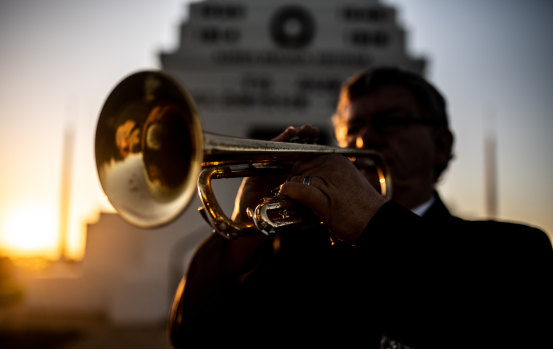 Afghanistan war veteran Duncan Clements plays his bugle at dawn at the Parkes War Memorial. 