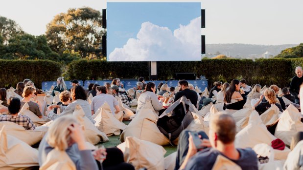 People sitting in front of the screen at the Manly Open Air Cinema