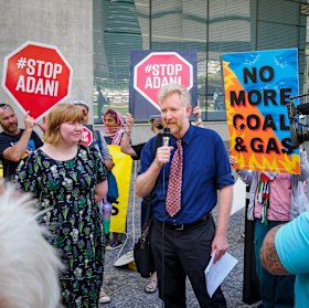 Ben Pennings with daughter Isabella and other activists outside the court in Brisbane.