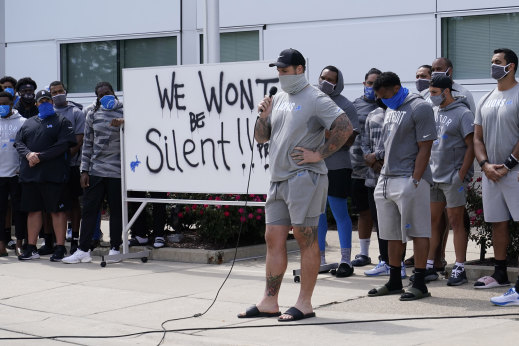 Taylor Decker of the Detroit Lions addresses the media with his teammates outside the team's practice facility.