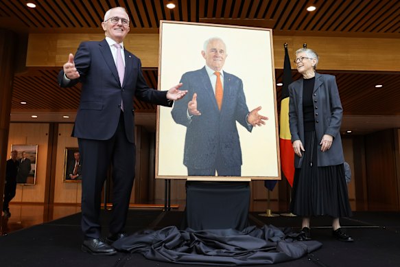 The moment the portrait emerges; on the right is artist Jude Rae. 